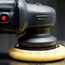 A close-up of a dual-action car polisher.